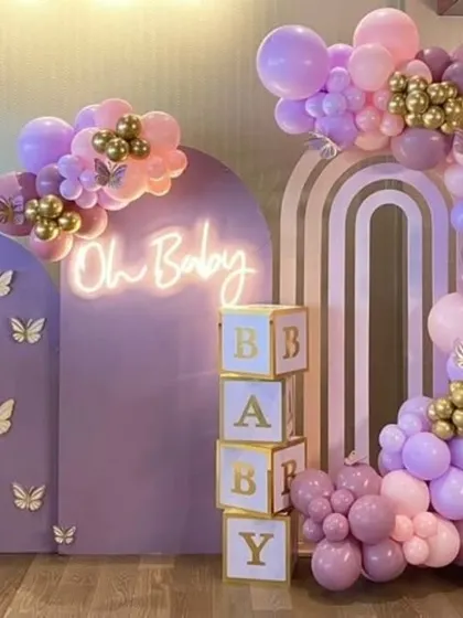 Another angle of the purple butterfly baby shower, showing the full arrangement and the "Oh Baby" neon sign.