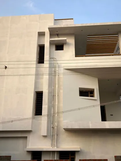 The house after plastering but before the final paint and cladding. This view clearly shows the building's geometric form and the interplay of solid walls and recessed windows.