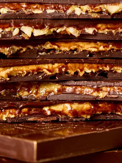 A stack of our Bombay Kaju Krunchy Bars, showing the delicious layers of chocolate, praline, and sev.