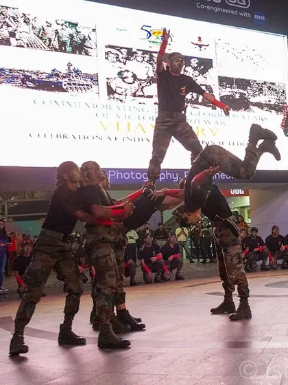 A dynamic shot of an Indian Army team forming a human pyramid during their performance at Cyberhub. For large public events, I focus on capturing impressive, coordinated action that showcases the scale of the celebration.