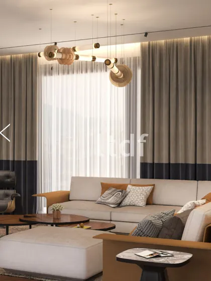 In this refined living space, form and function blend effortlessly. We used clean lines, a warm neutral palette, and thoughtfully layered textures to create an inviting atmosphere, anchored by a sculptural chandelier that adds a touch of modern artistry.
