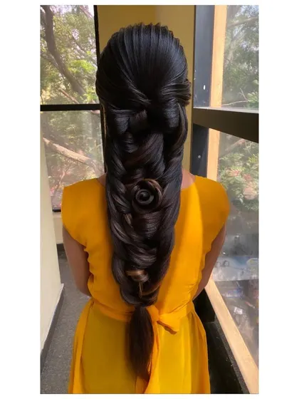 A highly intricate and advanced braid featuring a large, sculpted rose at the center. This is a masterpiece of hairstyling, perfect for competitions or a high-fashion bridal look.