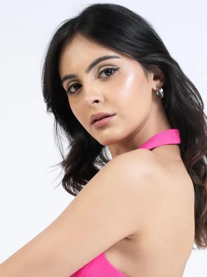 This angle highlights the winged eyeliner and the glowing highlighter on the cheekbones.