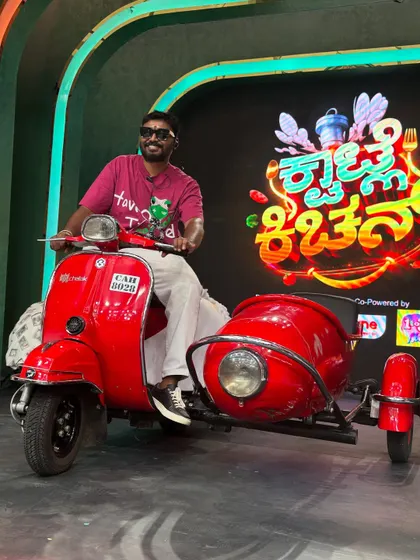 A full view of the vibrant 'Kwatle Kitchen' stage and the scooter prop I used for the performance.