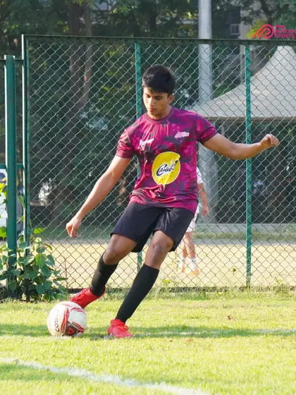 Close control and focus as a player moves the ball down the line.