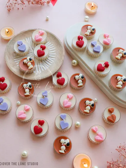 An assortment of my Snoopy and heart-themed tealights. Each Snoopy is hand-painted, and the hearts come in a variety of romantic colors.