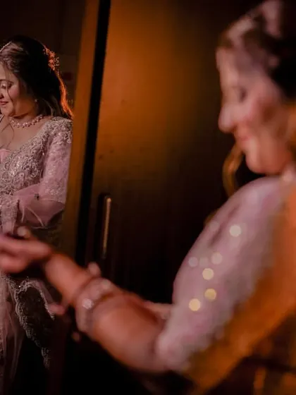 A playful moment as the bride-to-be dances in front of the mirror, admiring her look before the engagement party.