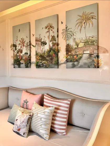 Another view of the three-piece wall art, showcasing how the panels tell a continuous story of a lush, imaginative landscape. They serve as a beautiful backdrop for the custom-styled cushions.