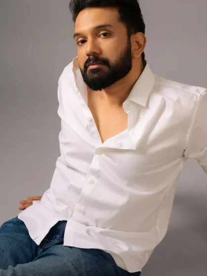 A classic white shirt and jeans look for Ankith Madhav. The grooming is effortless and masculine, perfect for creating a timeless and romantic vibe.