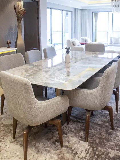 Here is our Elysian Marble Dining Table and Sora Dining Chairs in a Suncity residence we furnished. This project was about soft modernity, blending sculptural forms with tactile richness. The dining table's natural stone top with softly rounded corners, paired with the architecturally-inspired chairs, creates a space that is both grounded and effortlessly light.