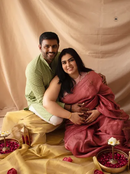 A happy and intimate portrait from a traditional maternity photoshoot. The warm colors and genuine smiles make this a cherished memory.