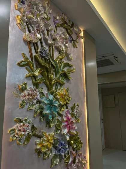 An angled shot of the floral mural, showing how it wraps around the corner and how the side-lighting enhances its three-dimensional quality.