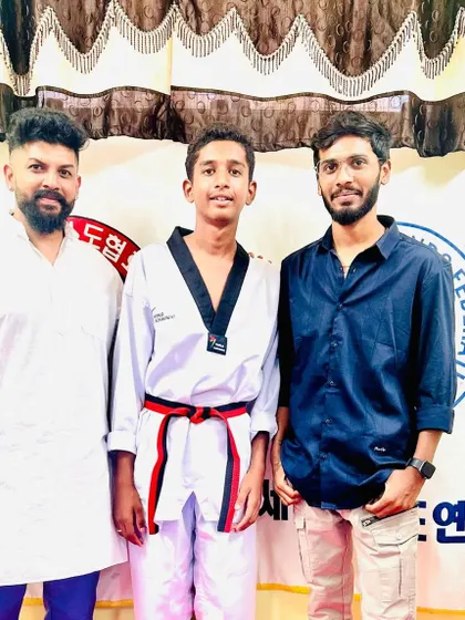 A student celebrates his new red belt.