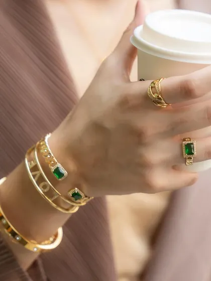 Another angle of this gorgeous gold and emerald stack, showing how the different bangles and rings catch the light.