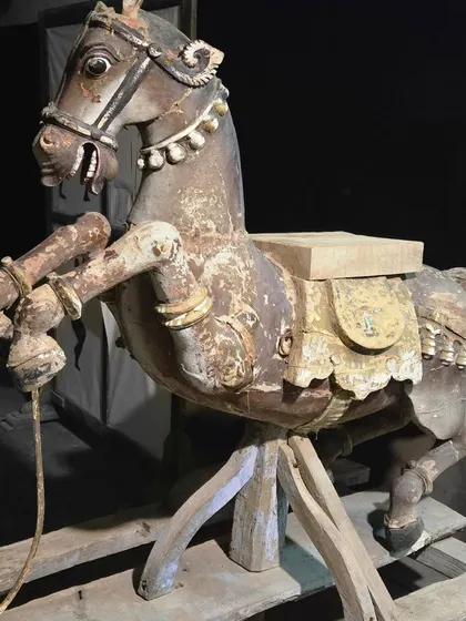 This weathered, hand-carved wooden rocking horse is a beautiful piece of antique folk art. Each crack and peel tells a story of its history, reminding us of a time when artisans poured their spirit into their craft.