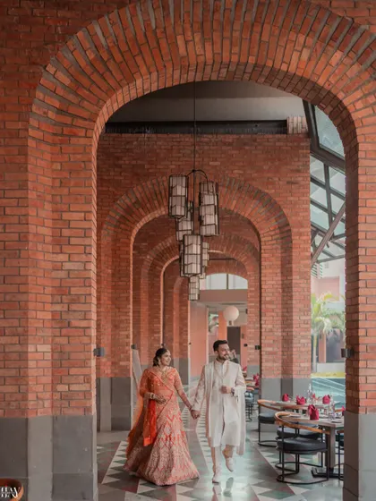 We love using dramatic architecture to frame your story. Here, we used the repeating brick arches of the Avadh Utopia resort to create a sense of grandeur and a beautiful leading line, capturing the couple in a candid, walking pose that feels both epic and natural.