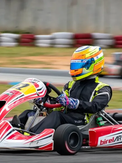 Hunner Singh in kart number 52, mid-race. His consistent top-five finishes are a result of a reliable kart and a strong driver-team strategy.