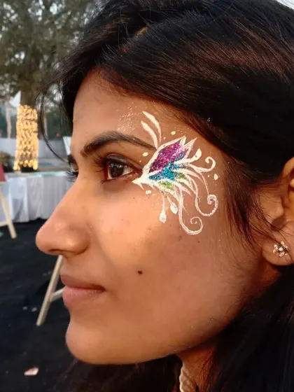 A whimsical design using white linework to create an abstract, airy butterfly. The multi-colored glitter in the center adds a beautiful pop of color that shifts in the light.