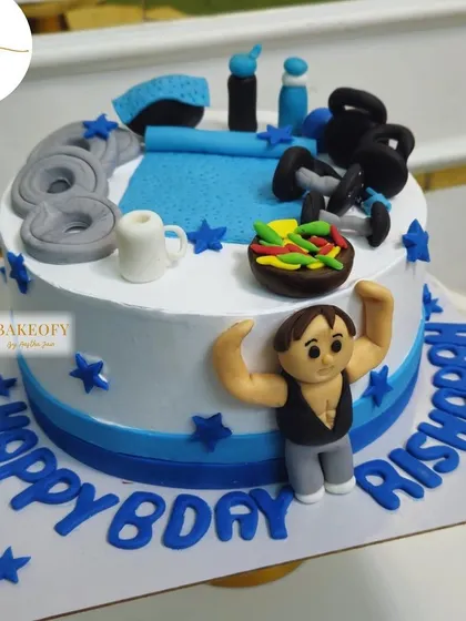 Pump up the celebration with this 1.5kg dark truffle cake for the ultimate gym freak. It's topped with fondant weights, a yoga mat, and even a tiny bowl of salad.