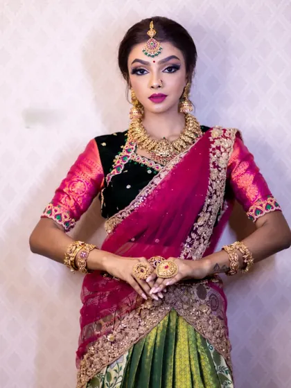 The full look is a celebration of color and tradition. The jewellery adds a touch of grandeur that is perfect for the festival of lights.