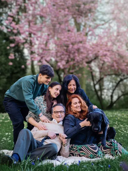 Who's the most pampered member of the family? It's clear from this fun, cuddly group hug under the spring blossoms that the dog holds a special place in everyone's heart.