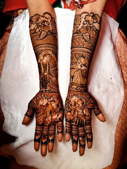 This design tells a story across both arms, with detailed figures of the bride and groom in their wedding attire, surrounded by family members and traditional patterns.