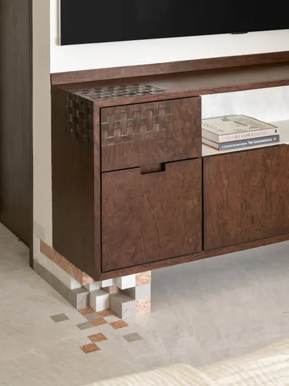A detail of the Gingham Dreams project, where playful, pixel-like marble details appear to support a floating burlwood media unit.