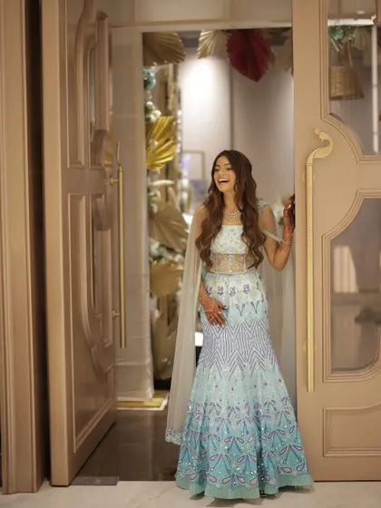 A full length shot capturing Rashi's joyful energy. Her entire look is cohesive, from the stunning lehenga to the flawless makeup.