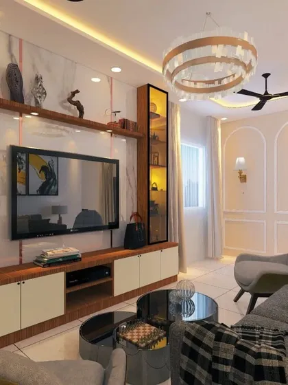A luxurious living room with a marble-finish TV wall, elegant wooden shelving, and a statement chandelier. The design creates a feeling of grandeur and sophistication.