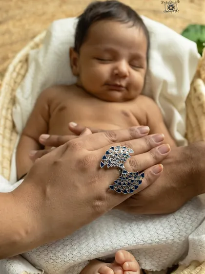 Your hands protecting their tiny body. These detail shots, showing the scale of how small they are in your loving hands, are some of the most powerful images from a newborn session.