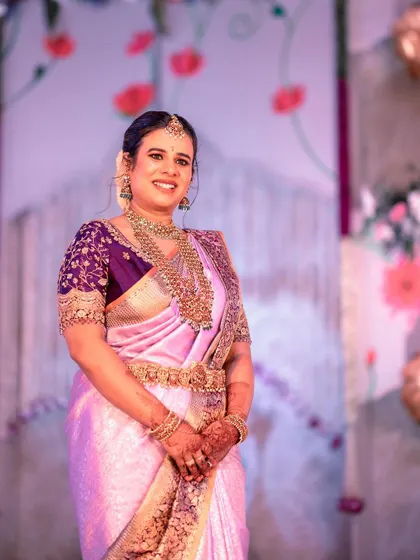 Anusha celebrating her son's naming ceremony. I designed this rich purple blouse with heavy zardosi embroidery on the sleeves to pair with her lavender Kanjeevaram silk saree.