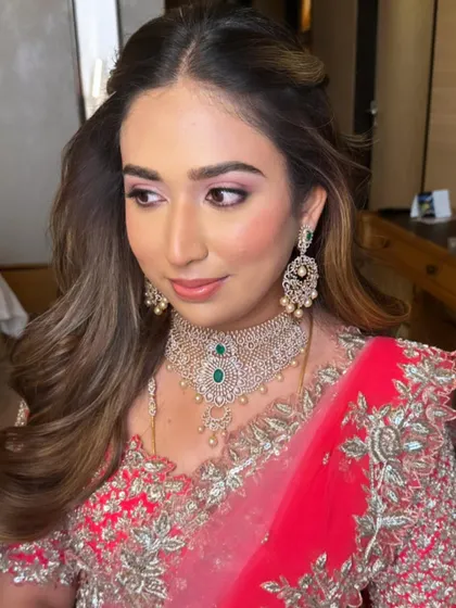 A side profile that captures the soft glam makeup and the beautiful waves in her hair.