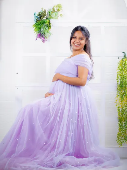 A seated portrait in our lavender Breezy gown. The dress drapes beautifully, creating a soft and elegant look in our studio.