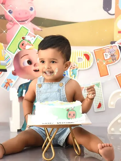 That "I got cake on my face and I love it" smile. A close-up from a Cocomelon cake smash session, capturing the messy joy of the moment.