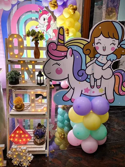 A close-up of the 'ONE' shelf and a cute unicorn cutout.