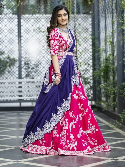 This side view highlights the unique silhouette of the sculpted skirt and the intricate, single-toned floral embroidery. The contrast-bordered dupatta and embellished waistband tie the whole look together.