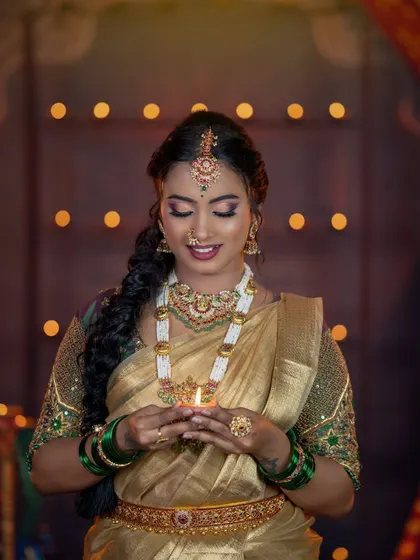 A serene moment from the Diwali shoot. The traditional jewellery glows in the warm light of the diyas.