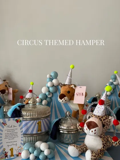 A shot of the circus-themed hamper with plush animals and decorative jars.