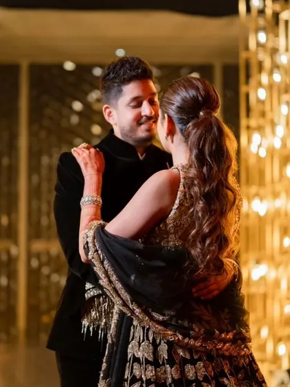 The couple shares a romantic moment in the golden, light-filled entrance tunnel.