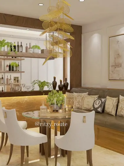 A wider view of the dining and bar area, showing the comfortable L-shaped banquette seating and elegant white chairs, blending comfort and style.
