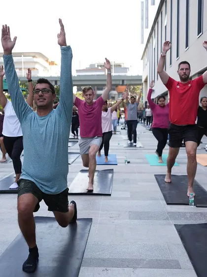 The Lululemon team fully immersed in the workout, holding a strong lunge. The focus and dedication in the crowd was palpable.