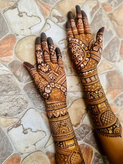 A breathtakingly beautiful bridal design, combining floral patterns, checks, and auspicious symbols.