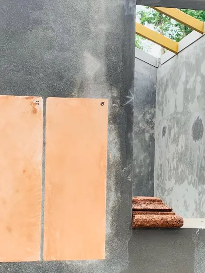 During the construction of a new Coorg home, I experiment with lime plaster swatches against the raw structure. This process is crucial for ensuring the final color and texture are in perfect harmony with the local laterite stone and the surrounding environment.