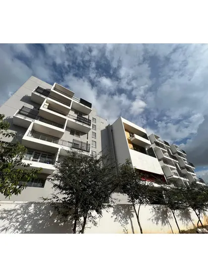 The play of light and shadow on the balconies of the 'Treehouse' apartment building. The facade's composition is designed to create a dynamic visual experience that changes with the time of day.