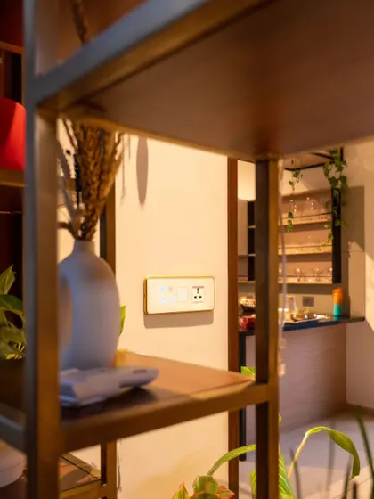 A smart panel with a gold frame, placed subtly on a shelf. It proves that control can be both accessible and beautifully integrated into your decor.