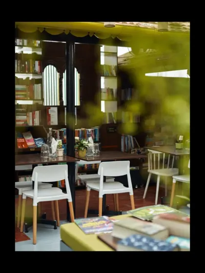 A glimpse into the cozy interior, where books and people come together. We used simple, honest materials and repurposed furniture to create a warm and unpretentious atmosphere.