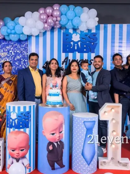 A happy family posing with their Boss Baby themed decor.