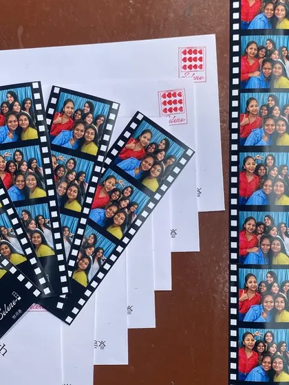 A collection of colorful photo strips with a film reel design, laid out with their matching envelopes. Every detail is considered.