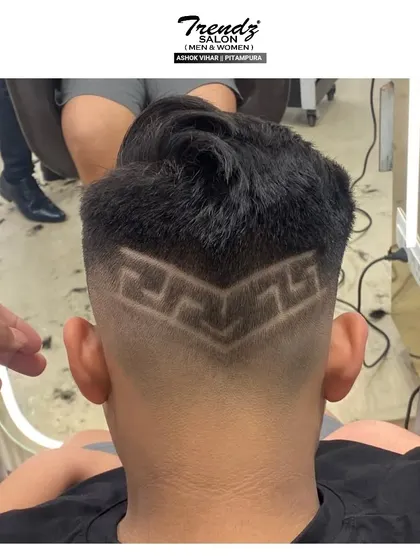 A cool and intricate geometric design carved into a fade. We love bringing our clients' creative ideas to life.