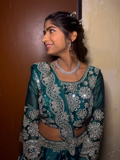 A side profile of the bridesmaid, showing her pretty smile and the delicate hair accessory.